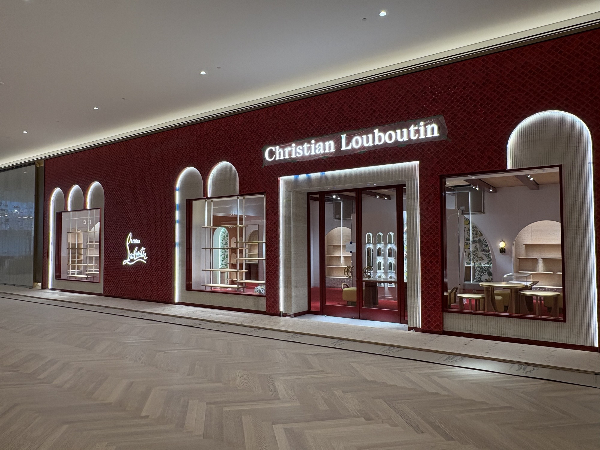 Christian Louboutin at Oakridge Park · Red storefront and arched openings