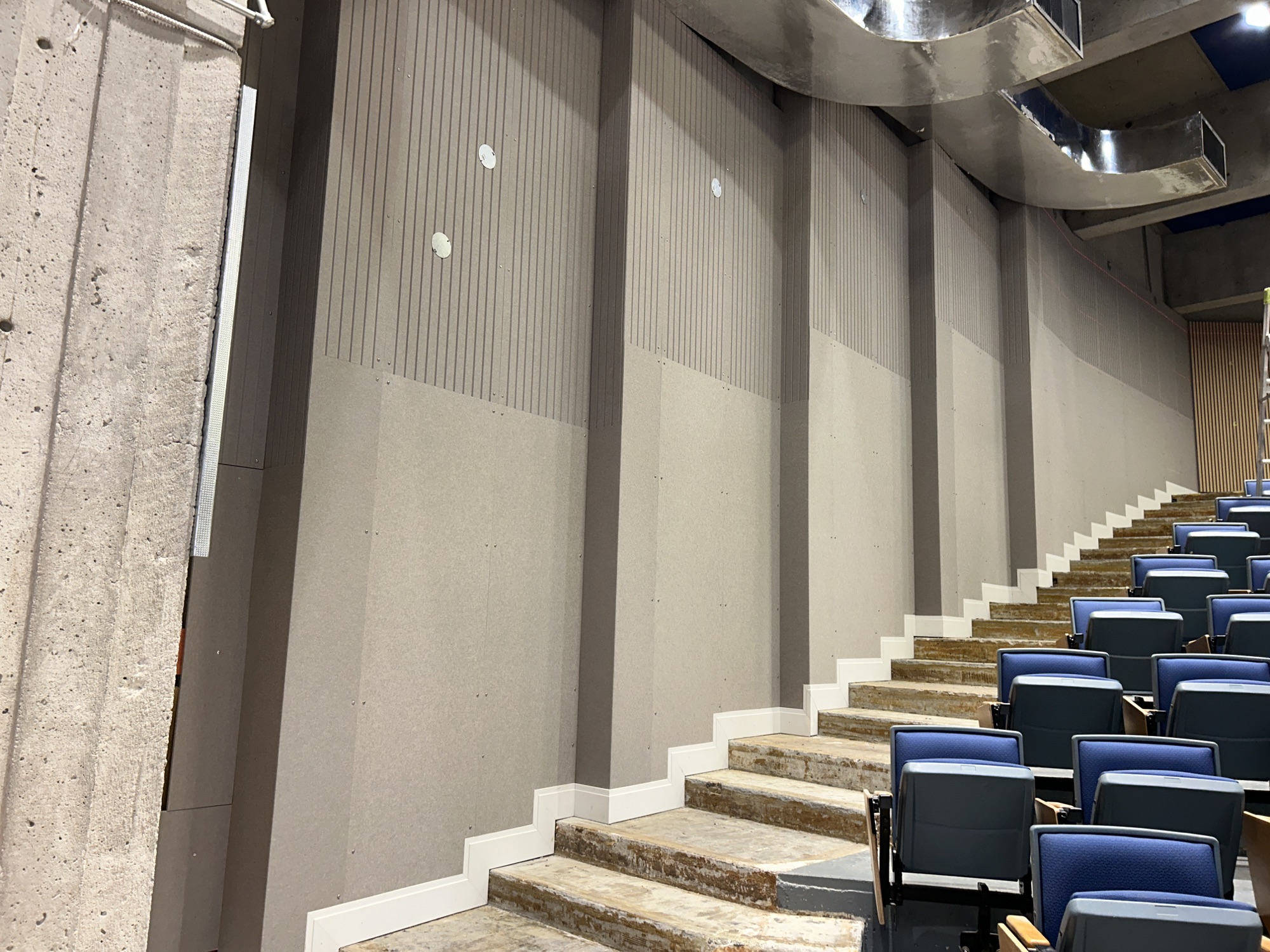 Tiered aisle and wall finishes during construction at SFU Images Theatre